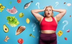 Fat girl in fitness suite wants to start a diet but has doubts about the food to buy. Cyan background