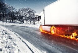 White truck with fiery wheels on a snow covered road