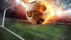 Close up of a fiery soccer ball kicked with power at the stadium scoring a goal