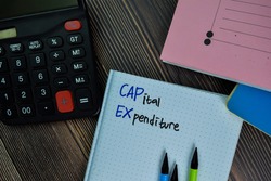 Capital Expenditure write on a book isolated on office desk.