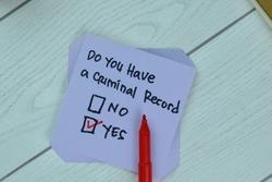 Concept of Yes, Do You Have a Criminal Record write on sticky notes isolated on Wooden Table.
