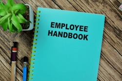 Concept of Employee Handbook isolated on Wooden Table.