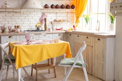 kitchen interior with yellow curtains and yellow tablecloth on the table