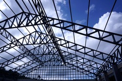 Roof structure is made of structural steel of the building with a long span column spacing. The building is not thatched roof. The steel truss structure of the building has a wide column span.