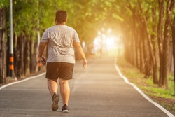 Exercise and healthy concept : Fat man running in the park