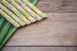 Top view fresh sugar cane and leaf on wooden background