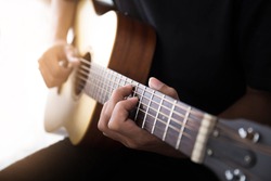soft selective and blur focus.musician playing folk guitar.concept for live music background,Music festival.Instrument on stage,abstract musical background.