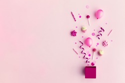 Collection of pink birthday party objects in a gift box