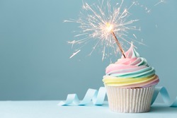 Pastel rainbow birthday cupcake with sparkler