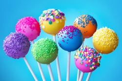 Brightly colored cake pops on a blue background