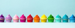 Row of colorful cupcakes in rainbow colors