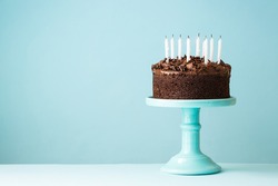 Chocolate birthday cake with blown out candles