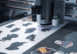 Digital cutting machine cutting cartoon graphic design on ABS plastic sheet