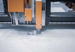 Digital die cut machine cutting plastic sheet. Industrial manufacture.