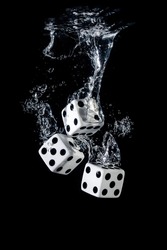 Dices sinking in water with bubbles on black background