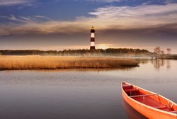 The lighthouse with landscape of marshlands and the lake soft blurry background.