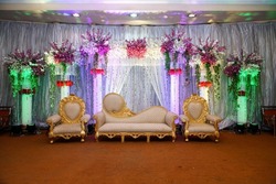 Wedding stage with floral background and lighting