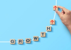 Wooden blocks arranged in curve shape with the word GROWTH. Business growth, career growth or growth concept.