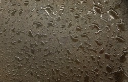 Wet water splotches on gray concrete stone floor. Abstract backdrop.