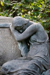 Weeping Sorrowfull Female Sculpture At A German Cemetery.