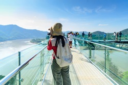 Tourists stand takephoto to travel at sky walk Viewpoint new landmark Thailand skywalk, at Phra Yai Phu Khok Ngio Chiang Khan, Loei Province, Mekong river Thailand