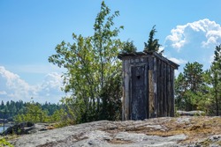 Outhouse, outdoor toilet on a cliff in archipelago landscape.
