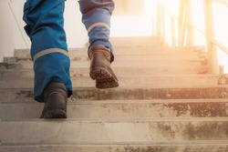 Person is stepping up the stairs with sunlight, Stepping to succeed, Break through obstacles