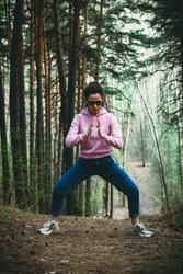 Woman practice Tai Chi Chuan in a park. Chinese management skill Qi's energy. solo outdoor activities. Social Distancing