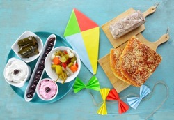 Colorful kite and fasting food for Clean Monday on turqoiuse table