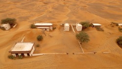 Abandoned village covered by sand dunes aerial view