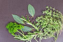 close up of various of herb ingredients for flavor and seasoning in cuisine such as sage, rosemary, parsley and thyme, isolated background.