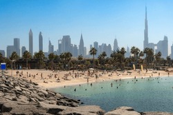 Panoramic view of popular La Mer beach in Dubai, UAE. Coastline with azure sea and high rises in background, United Arab Emirates. High quality photo