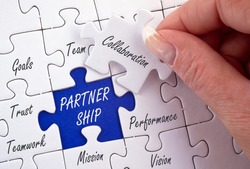 Partnership Business Concept with female hand and puzzle