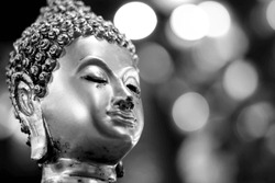 Black and white image of a beautiful sacred Buddha face in Asia, highly revered by people.