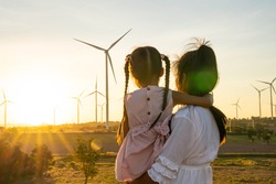 Wind turbines are alternative electricity sources, the concept of sustainable resources, People in the community with wind generators turbines, Renewable energy.