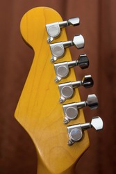 Electric guitar tuners on vintage maple neck headstock, silver guitar tuners