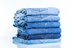 
Jeans trousers stack on white background.concept  jean in supermarket.