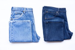 Blue jeans in a row, stack of denim pants, composition, denim texture.