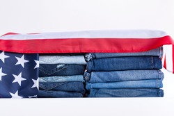 Jeans stack on a white background in store and supermarke and flag USA.concept fashion dress jeans.
