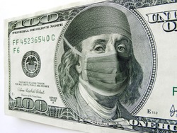 Photo illustration of Ben Franklin wearing a health care mask and bonnet on a one hundred dollar bill. Might illustrate the high cost of health care during the Coronaviruse Pandemic.