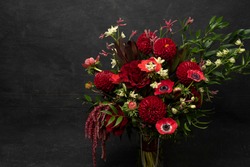 Dark red dahlia, rose and anemone bouquet floral flat lay
