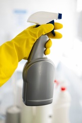 girl hotel worker in rubber gloves with cleaning products does cleaning in the bathroom with a means for cleanliness and disinfection