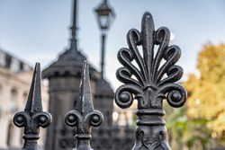 Shallow focus on a fleur de lis shaped iron gate in Jackson Square, French Quarter, New Orleans.