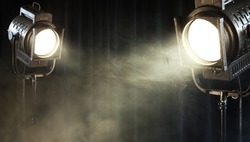 theater spot lights on black curtain with smoke