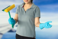 Female cleaning staff on sky and airplane blurred background Metaphor for cleaning Get rid of germs In bathroom, home office or industry.For reliability And satisfaction of service and customers.
