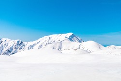 The snow mountains wall of Tateyama Kurobe alpine or japan alps in sunshine day with  blue sky background is one of the most important and popular natural place in Toyama Prefecture, Japan.