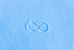 The sign of infinity on the snow. Blue snow, frosty morning. 