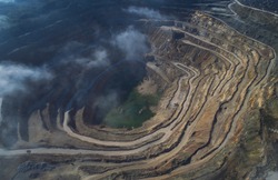 Aerial view of opencast mining quarry with lots of machinery at work - view from above.