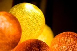 Yellow orange glowing balls. Orange glowing balls. Yellow glowing balls. Glowing balls on garland