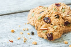 Pumpkin, oat cookies with cranberries, almond on wooden background